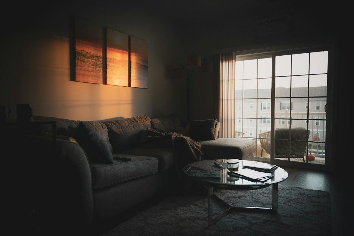 Sectional sofa living room at dusk with glass doors and a coffee table